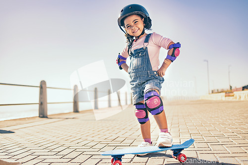 Image of Summer, happy and little girl portrait with skateboard for holiday in Los Angeles with sky mockup. Vacation, sidewalk and cute black child with helmet ready to skate for wellness, health and fun.