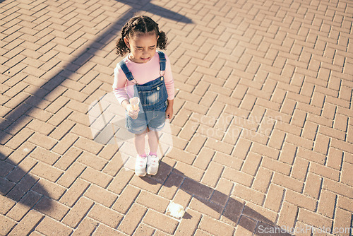 Image of Crying kid drop ice cream on floor, ground and street in summer, sunshine and outdoors. Sad, unhappy and frustrated girl child in tears for icecream accident, messy dessert mistake and candy problem