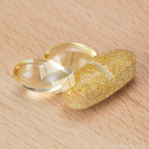 Image of Fish oil capsules and multivitamin tablet on a table