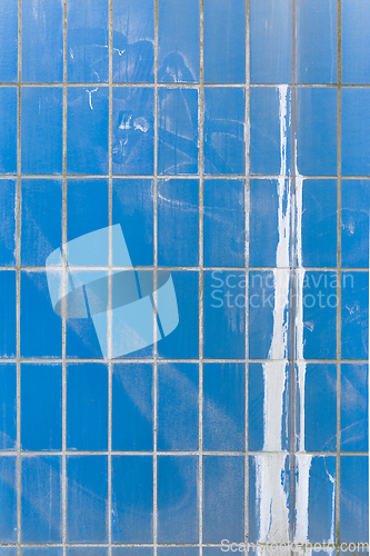 Image of Blue ceramic tile wall with paint splash