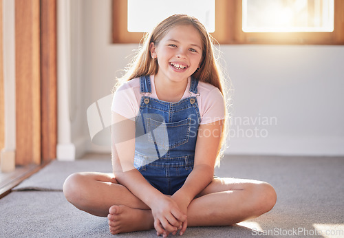 Image of Portrait of happy girl, kid and child on living room floor, carpet and ground for fun, play and happiness alone. Excited youth, smile children and one female relax in lounge, house and family home