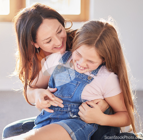 Image of Happy, love and mother bonding with her child while playing, laughing and relaxing together at their home. Happiness, smile and woman being playful with her girl kid in their modern house in Canada.