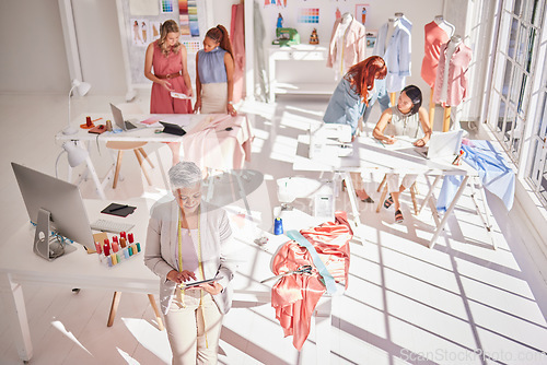 Image of Fashion workshop, diversity or women working with tablet, fabric or design research for creative clothing strategy. Collaboration, teamwork or designer woman in workshop or manufacturing factory