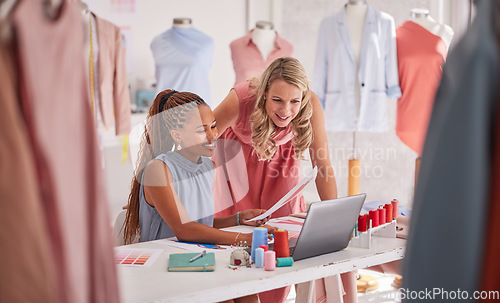 Image of Fashion designer, women and laptop in teamwork collaboration with paper design, color thread or clothing vision. Smile, happy or creative seamstress with technology, documents or fabric worker mentor