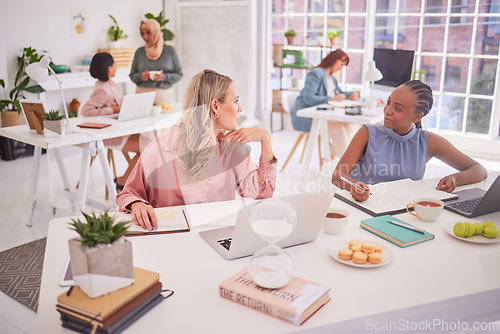 Image of Business women, creative and planning in office with laptop and book for notes, writing and sharing ideas. Business people, brainstorming and group discussing strategy for problem solving together