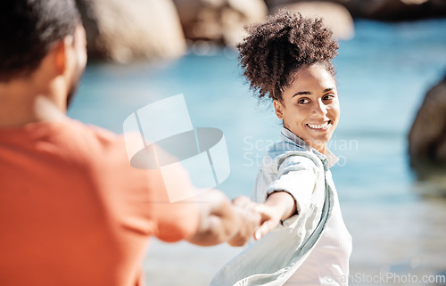 Image of Black couple, beach and vacation while holding hands for love, adventure and travel together in nature with love, care and trust. Women leading man to follow into water while on holiday in summer