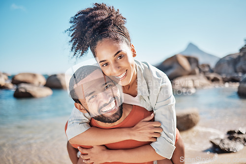 Image of Couple, piggyback or bonding on beach by ocean, sea or rock pool water in Brazilian summer holiday. Portrait, smile or happy man carrying woman in fun activity, love or support trust in nature travel