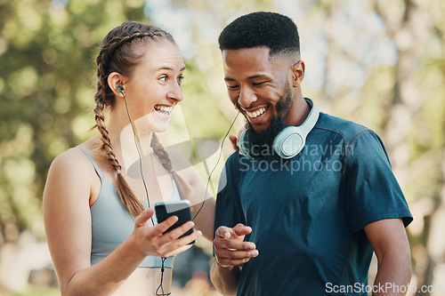 Image of Phone, music and fitness with a diversity couple listening to audio while outdoor for running exercise together. Happy, fun and streaming with a man and woman athlete outside for a training workout