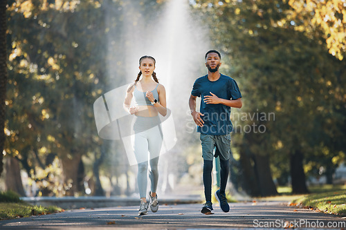 Image of Couple running, fitness and runner in park for exercise and cardio with body training outdoor. Interracial, black man and woman run in nature, workout and sports for healthy active lifestyle.