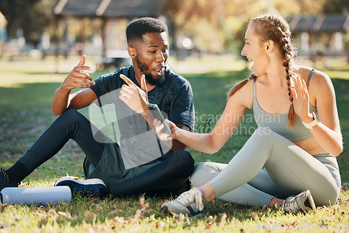 Image of Music, phone and earphone couple in park on fitness run break rap, singing and listen together. Streaming, tech and interracial people listening to feel good beats with mobile app to relax.