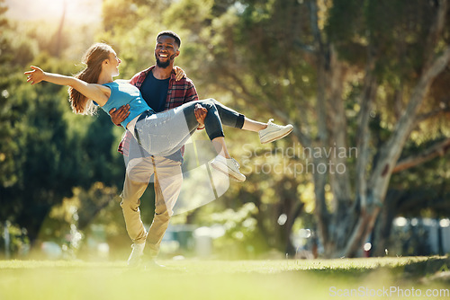 Image of Crazy couple, carry and happy smile, fun and enjoy date in nature park, romance and care while running together. Interracial man, woman and love with happiness, freedom and energy in garden or forest