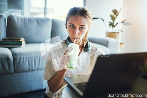 Image of Student, laptop and smoothie for education, digital elearning and research for college in living room. University, studying and school woman, working on email, project or online exam with drink