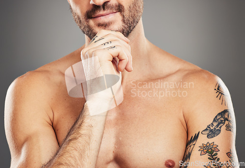 Image of Thinking model, body and arm tattoos on gray studio background with shirtless chest, strong muscles or bodybuilding progress. Zoom, fitness man and boydbuilder person trainer with training goals idea