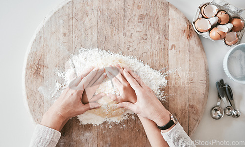 Image of .Baking, learning and family hands of a mother and girl teaching pizza, bread or cake cooking. Above view of mama and kid hand together with care and love in a home kitchen with flour for food.