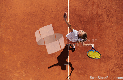 Image of Top view of a professional female tennis player serves the tennis ball on the court with precision and power