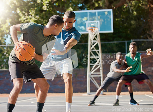 Image of Basketball, sports and competition with a black man athlete playing a game on a court with friends or a rival. Team, fitness and health with a male basketball player training on a basketball court