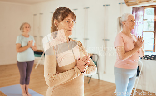 Image of Yoga, relax and retirement wellness class for health, mindfulness and spirituality lesson. Namaste, zen and calm senior women focus together in wellbeing club for a healthy mind and body.