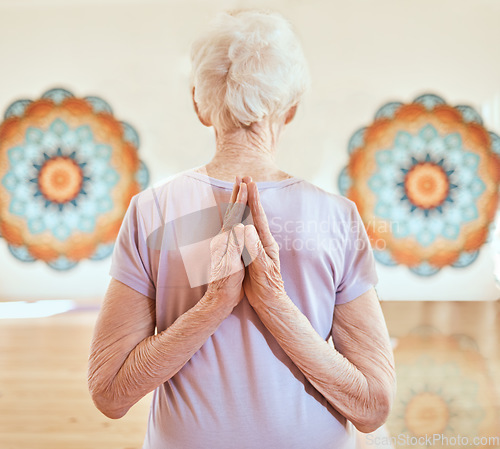 Image of Elderly woman in pose for yoga, flexibility and fitness in studio, hands with arms stretching and vitality in old age. Balance, exercise and chakra with peace and body training and wellness.