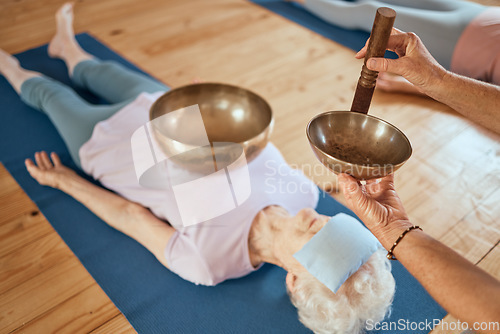 Image of Singing bowls, meditation and senior woman on floor for healing, vibration and sound therapy with healer. Sound healing, zen and elderly lady on a ground for tibetan bowl music, relax and wellness