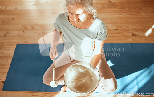 Image of Sound healing, bowl and senior yoga woman practice alternative medicine for aura, soul or chakra energy balance. Audio holistic healthcare, music therapy and top view of yogi with singing bowl
