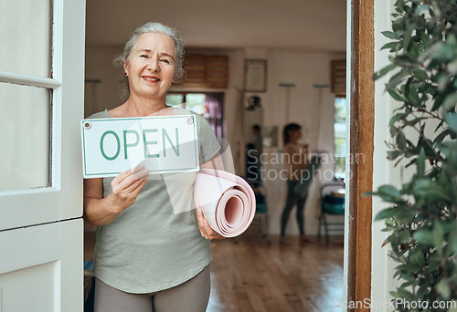 Image of Woman, portrait and advertising open sign, yoga studio and fitness club, healthy lifestyle and senior wellness. Happy old woman at door of exercise, workout and training center with marketing signage