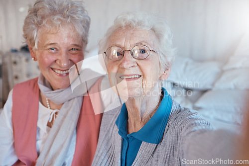 Image of Senior women, friends and selfie with a smile, happiness and care during a visit or lifestyle in a nursing home together. Face portrait of old people happy about retirement, support and trust