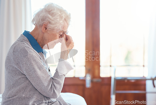 Image of Senior woman, headache and stress with anxiety in retirement house, lonely and sad with mental health. Elderly female, depression and frustrated with fear for health, fail and mad with grief problem