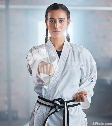 Image of Woman, karate and punching pose in taekwondo fitness, workout or training for black belt competition, fight challenge or self defense. Portrait, martial arts and judo sports person in power exercise