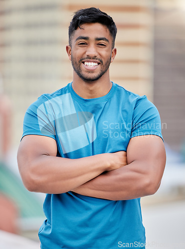 Image of Fitness, exercise and portrait of a sports man standing arms crossed outdoor with a smile on his face. Workout, health and happy with a male athlete training outside for cardio or strong muscles