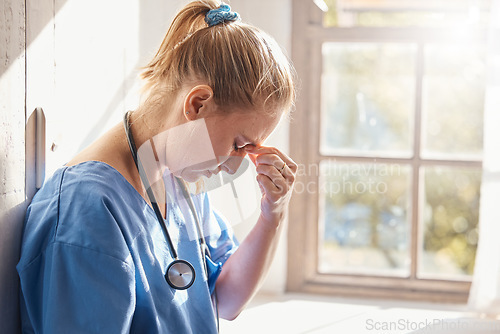 Image of Headache, stress and burnout of woman doctor, sad worker and medical employee. Frustrated, depression and tired nurse in hospital, mental health challenge and anxiety, pain and emotion of bad news