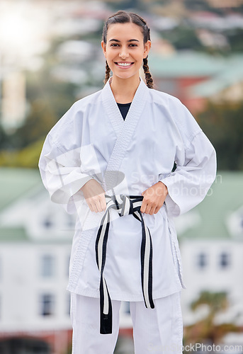 Image of Woman, karate and smile in outdoor portrait with happiness for training, fitness and wellness in sunshine. Girl, martial arts and self defence with happy, sport and motivation in metro, town or city