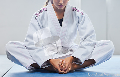 Image of Warm up, legs and woman in karate training, learning martial arts and focus before a fight. Fitness, performance and feet of girl in taekwondo class for body power, self defense and start of exercise