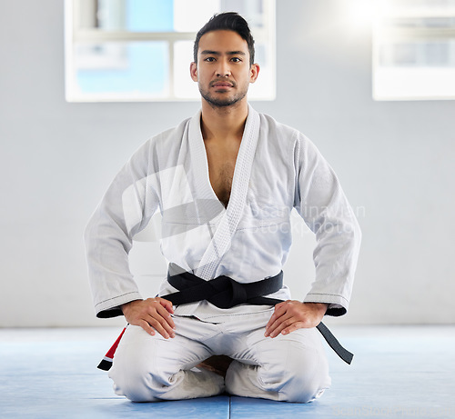 Image of Portrait, karate and sensei with a sports man kneeling on the gym floor of a dojo or fitness club for self defense. Training, workout and fight with a martial arts professional in a sport facility