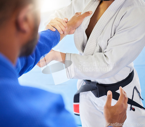Image of Man, closeup and karate training fight in gym, dojo and combat sport for exercise. Man, self defence and workout with black belt sensei at fitness club for body health, balance or martial arts sports