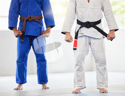 Image of Karate, uniform and men in dojo, uniform and start training, exercise and workout with commitment and motivation. Fighter, uniform and coach with coaching, fitness and sports practice in gym or club