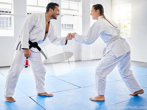 Image of Fist bump, support and couple in karate, training and teaching in partnership for motivation in self defense. Goal, fight and man and woman with unity in taekwondo for exercise and fitness at a club
