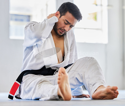 Image of Karate, sports injury and neck pain of man at fitness club for martial arts, exercise and training to fight for competition. Athlete male tired after taekwondo, sport and training with health problem