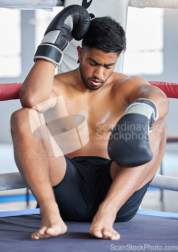 Image of Mma, boxer and man sad, loss and defeat in ring from sports boxing match at the gym or arena. Angry male athlete in fight club, fatigue and depression from fighting sport workout or training exercise