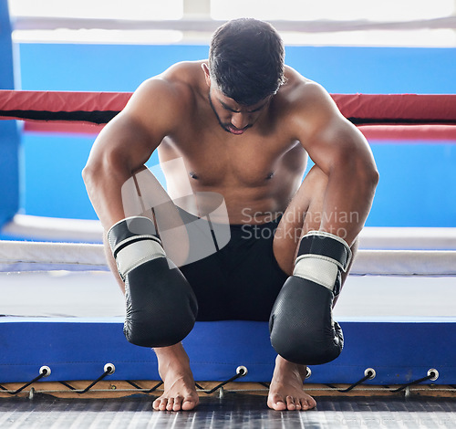 Image of Boxer, martial arts and man tired and sad after boxing or sports competition mistake, failure or stress, anxiety and depression pre workout. Athlete man worried about exercise or fight at boxing ring