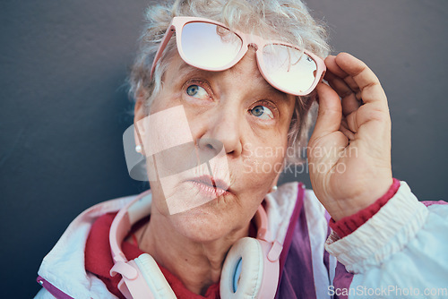 Image of Fashion, trendy and senior woman in city standing by grey wall with stylish, urban and cool outfit. Pensioner, freedom and fashionable elderly female in retirement with modern clothes in town street.