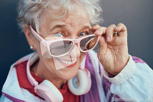 Image of Face portrait and senior woman with sunglasses, headphones and vintage clothing. Fashion, beauty and happy, retired and elderly female in retro, cool and pink designer glasses and outfit with smile.