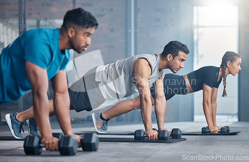 Image of Fitness, teamwork and group with weights, focus and training for a body goal together in the gym. Exercise, power and strong friends in a kettlebell class for a strength training workout at a club