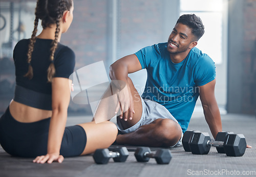 Image of Happy couple, fitness and exercise with personal trainer and client talking about wellness, health and workout plan on gym floor. Happy indian man and woman together for training and motivation
