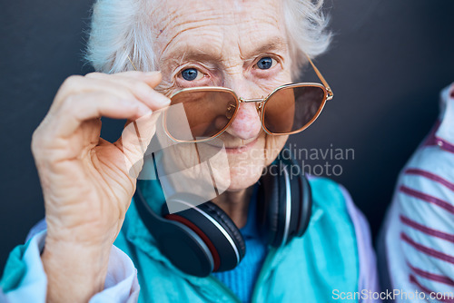 Image of Glasses, cool and fashion portrait of old woman with music headphones, luxury senior style or creative accessory. Vision, wellness and face of elderly retirement person with designer brand sunglasses
