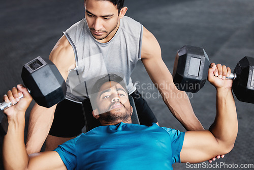 Image of Fitness, dumbbell training and personal trainer men with support, trust and muscle help in gym together. Helping, coaching and motivation of coach for man bodybuilder challenge, exercise or workout
