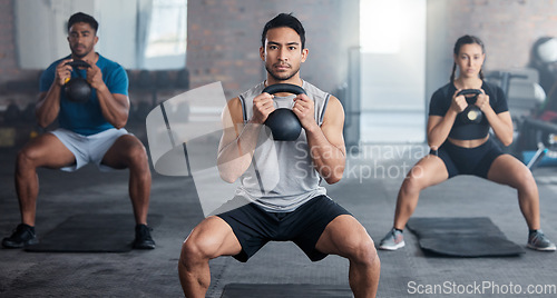 Image of Fitness, workout and kettlebell with a personal trainer in class with a group of students for exercise. Portrait, gym and strong with a coach weight training a man and woman athlete in a sports club