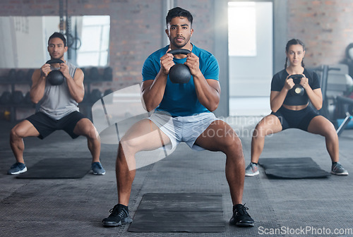 Image of Fitness, kettlebell and personal trainer with a man coach training a class in the gym for health. Exercise, workout and bodybuilder with a male athlete teaching students in a club for strong muscles