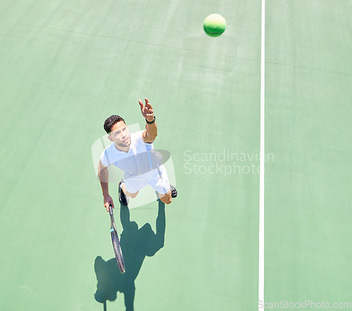 Image of Start, above and man playing tennis on court for fitness, workout and training for a competition. Exercise, sports and professional athlete serving during a game of sport with focus in a match