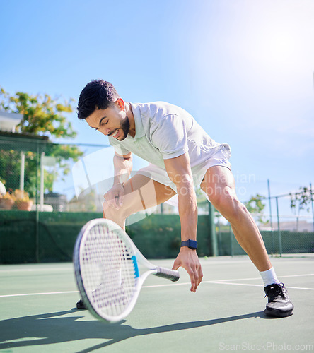 Image of Sports, tennis and leg injury on court after training, game or match. Tennis player, healthcare and male athlete drop racket with injured knee, muscle pain or inflammation after workout or exercise.