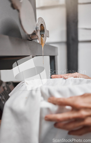 Image of Honey, production and basket with food production of a sustainability farming and honeycomb liquid. Gold wax harvest with farmer hands holding a cloth to catch organic and eco friendly product